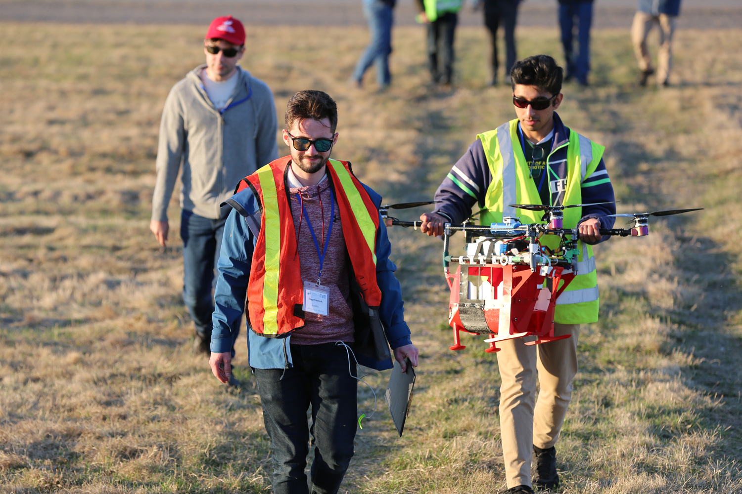 Students with drone on a field