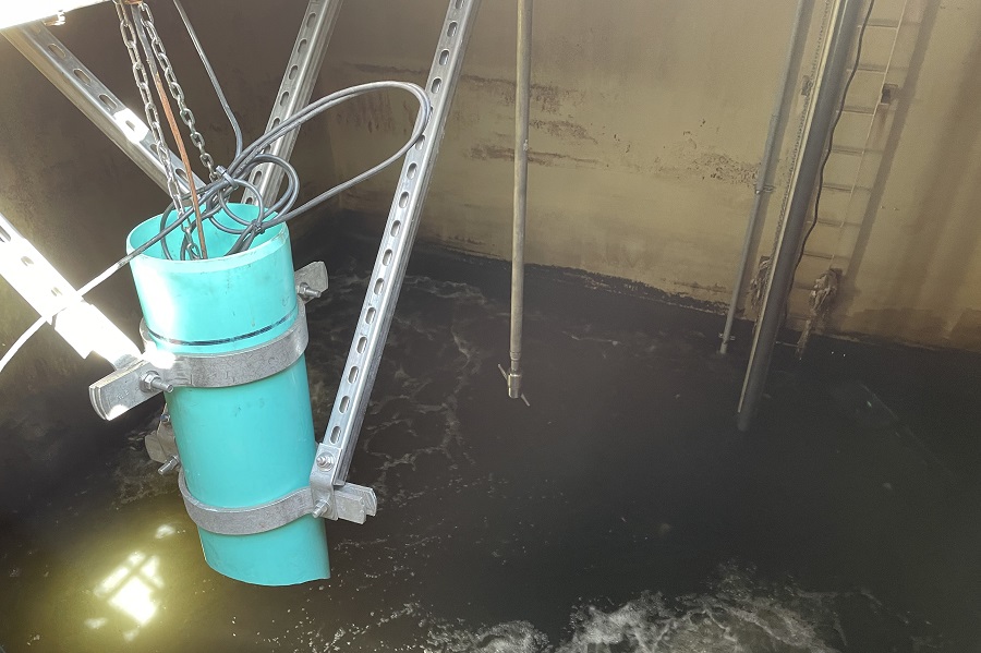 View inside sewage holding tank, featuring two processing apparatus above the waterline